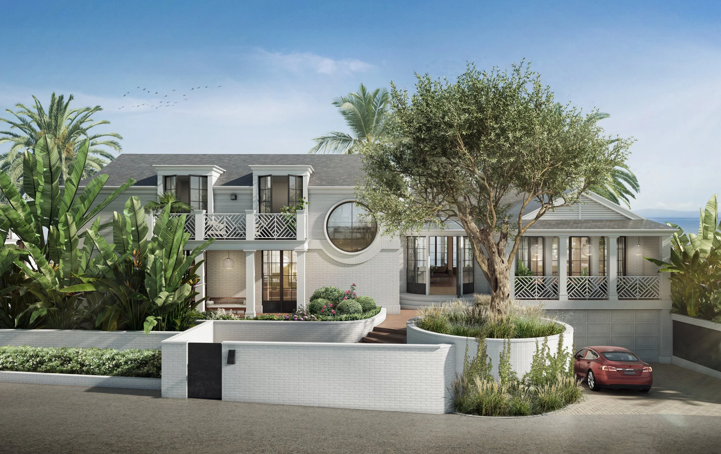 Front exterior view of Edgecliff Residence by The Warner Group Architects, featuring a coastal-style home with lush landscaping, palm trees, and a circular window, located near the ocean in Santa Barbara.