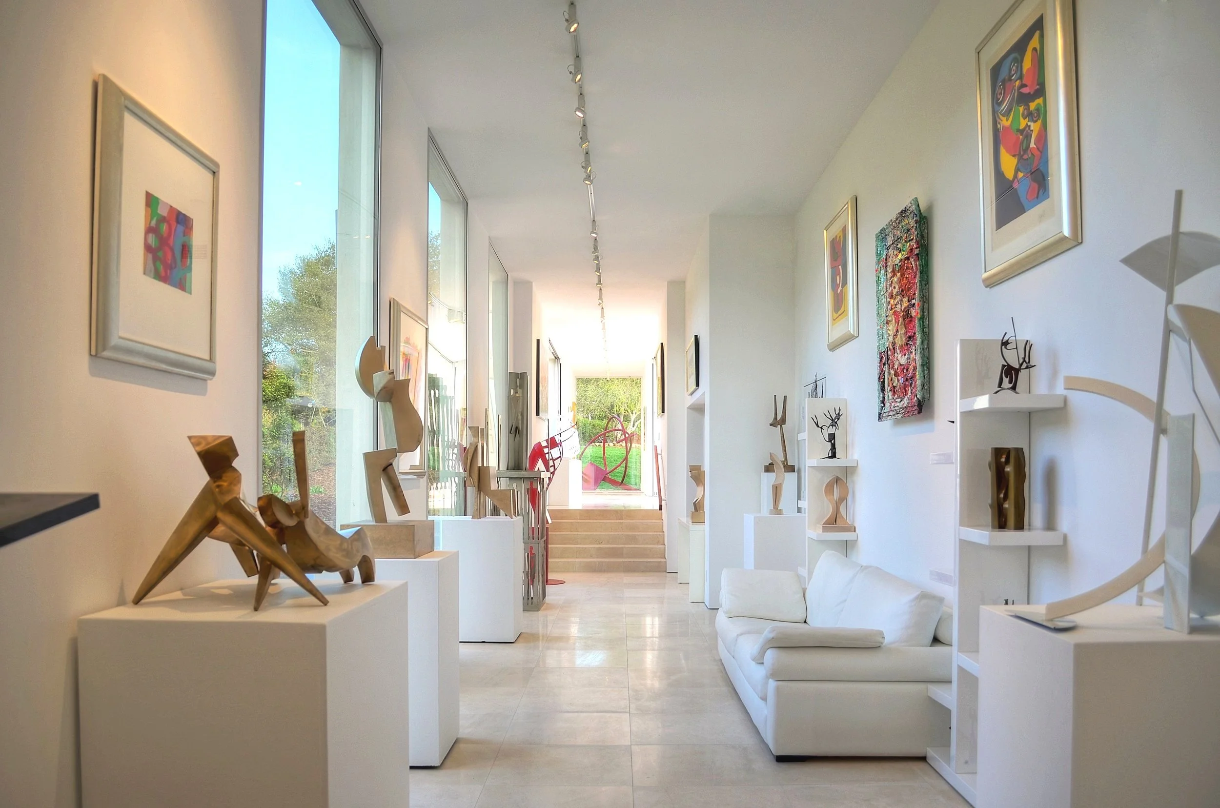 Modern art gallery interior with sculptures and paintings