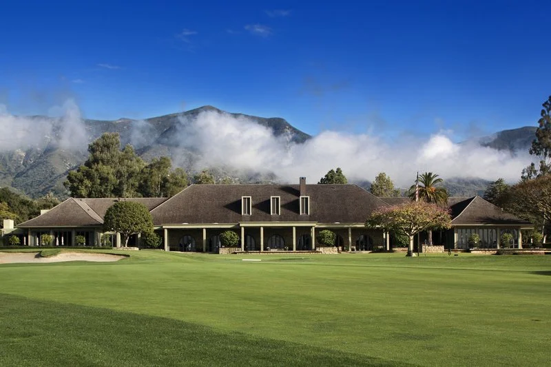 Golf clubhouse with mountains and clouds