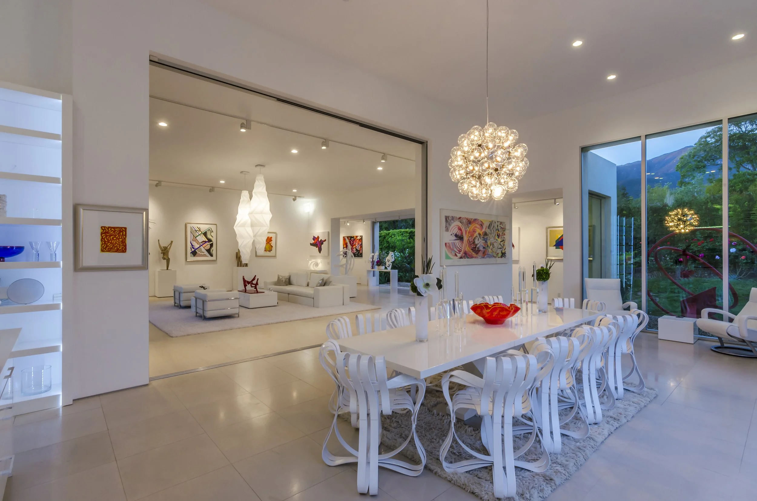 Spacious dining area and modern art-filled living room, featuring a wall to wall partition to easily separate the dining room from the living room.